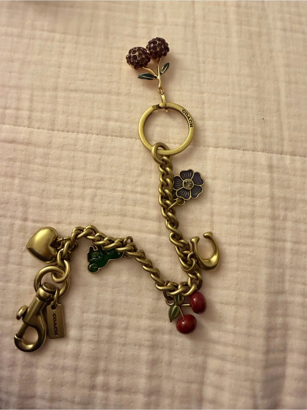Coach Gold-Tone Charm Bracelet with Red Cherry & Purple Flower Accents